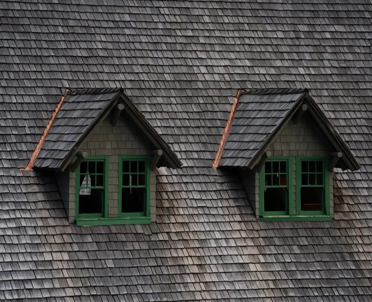 Dormers on a shingle roof in Stamford, CT, where step flashing and kickout flashing carry water past the walls